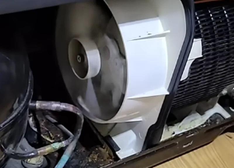 Technician accessing the motor and belt assembly inside a home laundry appliance in Spartanburg SC