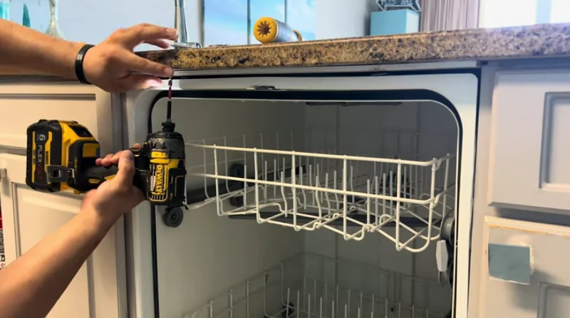Dishwasher being secured and levelled under a countertop during an installation check in Spartanburg SC