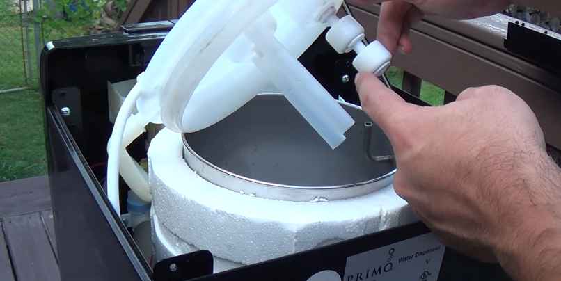 Technician servicing a refrigerator ice and water dispenser assembly in a Spartanburg SC home