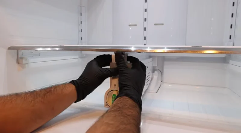 Technician repairing a refrigerator cooling system inside a Spartanburg SC home