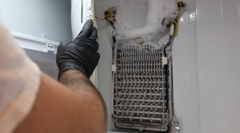 Frost buildup on refrigerator evaporator coils being cleared during a defrost system repair in Spartanburg SC