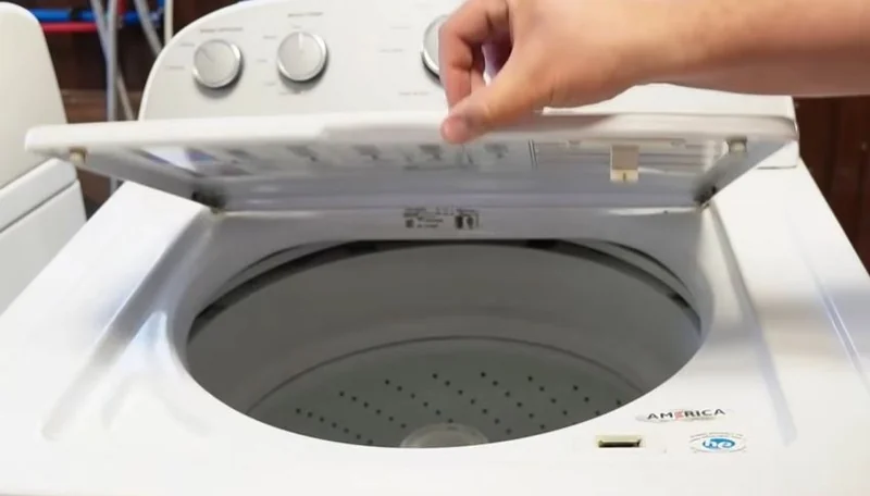 Top-load washing machine opened for inspection during an in-home repair in Spartanburg South Carolina