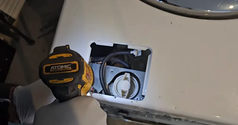 Technician checking a 240V appliance power connection during a laundry repair in Spartanburg SC
